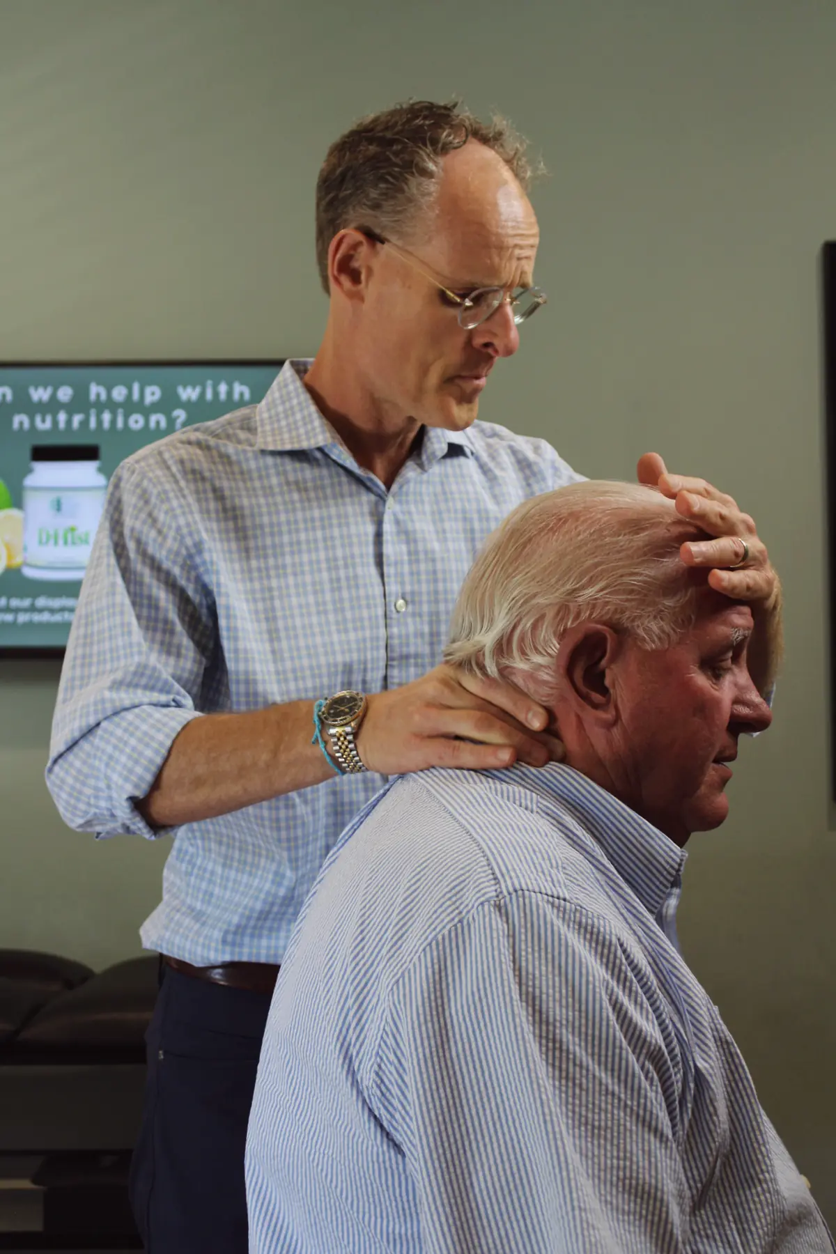 Dr. Scott Sweeney caring for a patient in his Austin, TX chiropractic studio